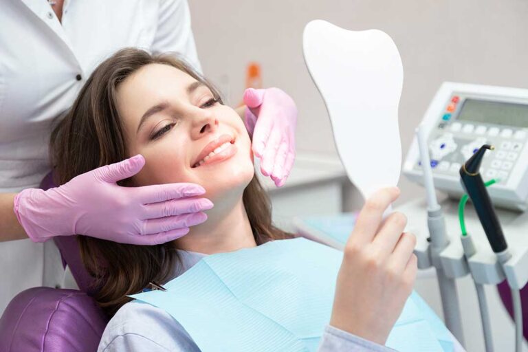 A person holding a toothbrush at a 45-degree angle to the gumline while brushing their teeth.